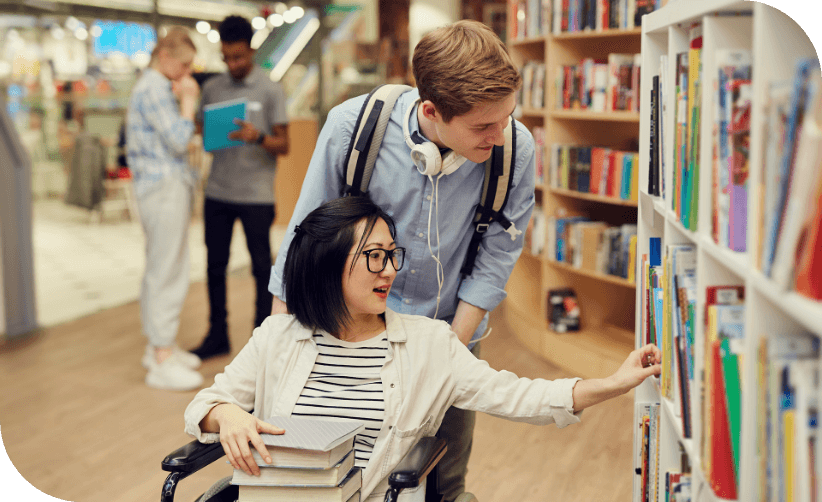 Student woman in wheelchair in library