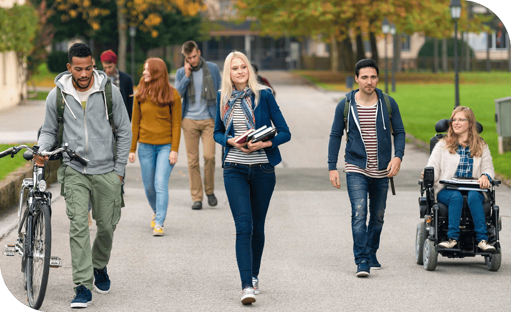 Students walking together after class with a student in a wheelchair.